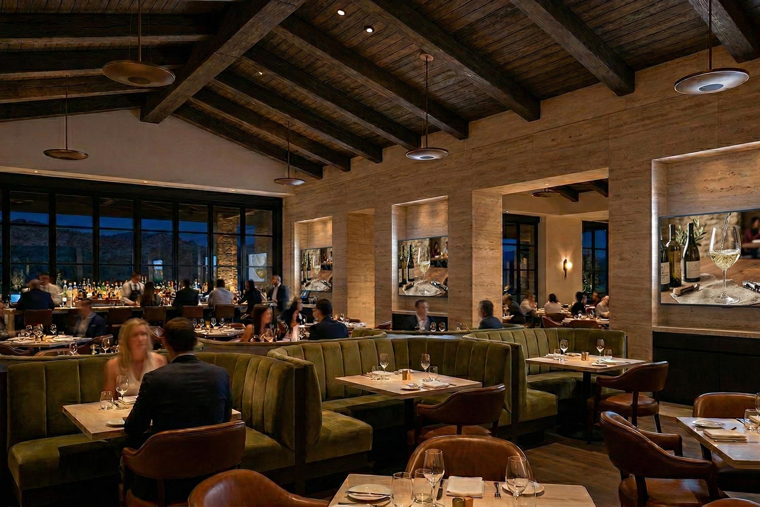 Upscale restaurant dining room with multiple display screens on stone pillars
