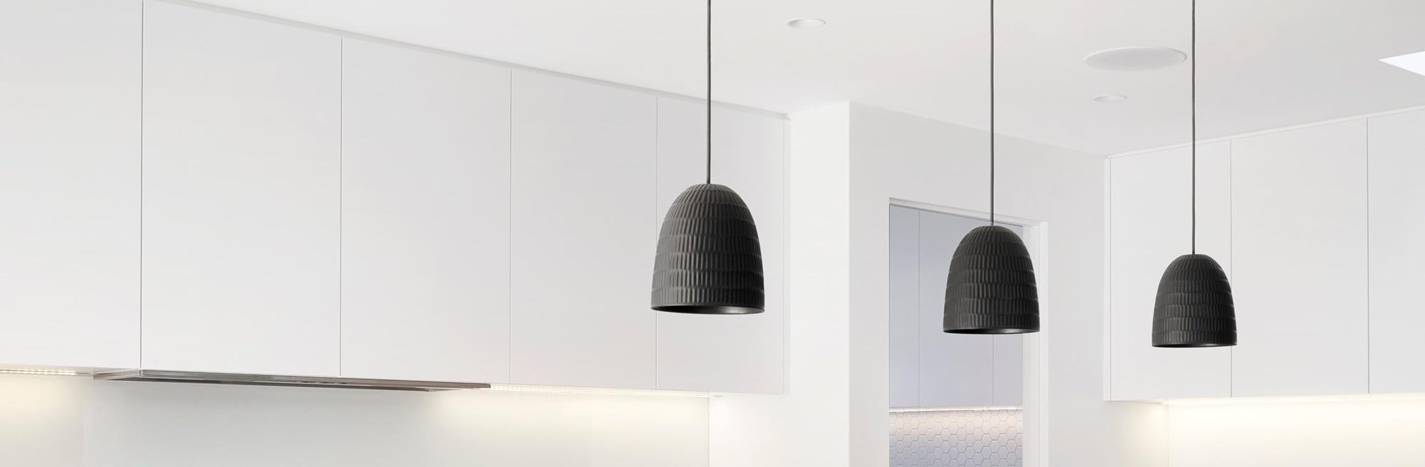 Modern horizontal linear pendant lights hanging over a wood dining table on a yacht