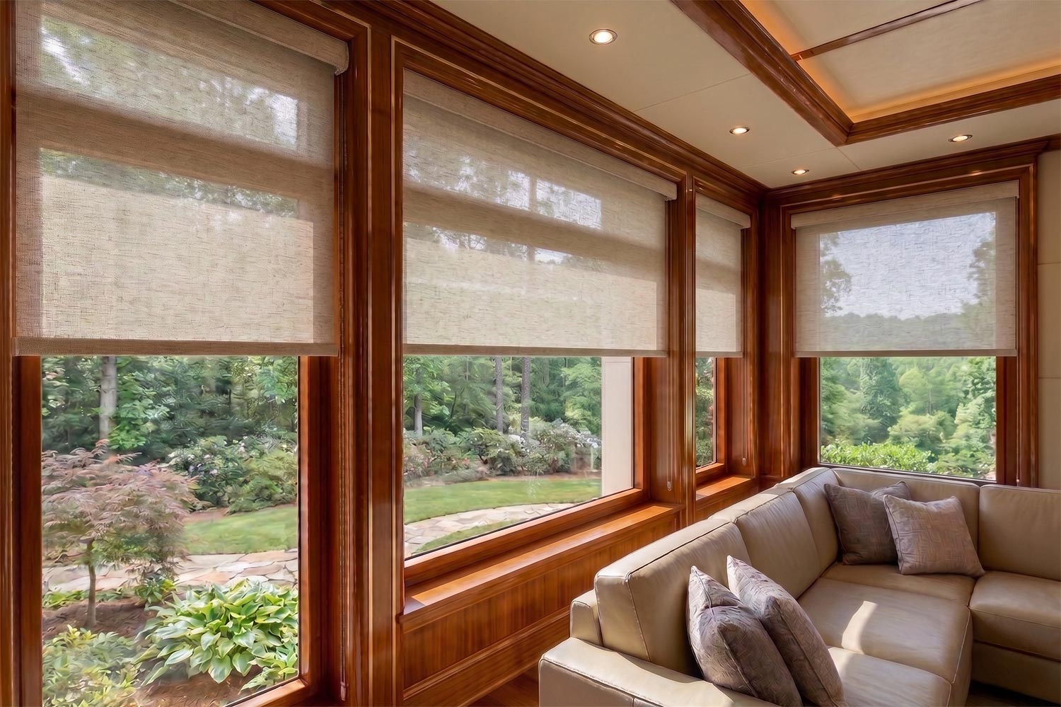 Roller shades lowered over large windows in a luxury living room